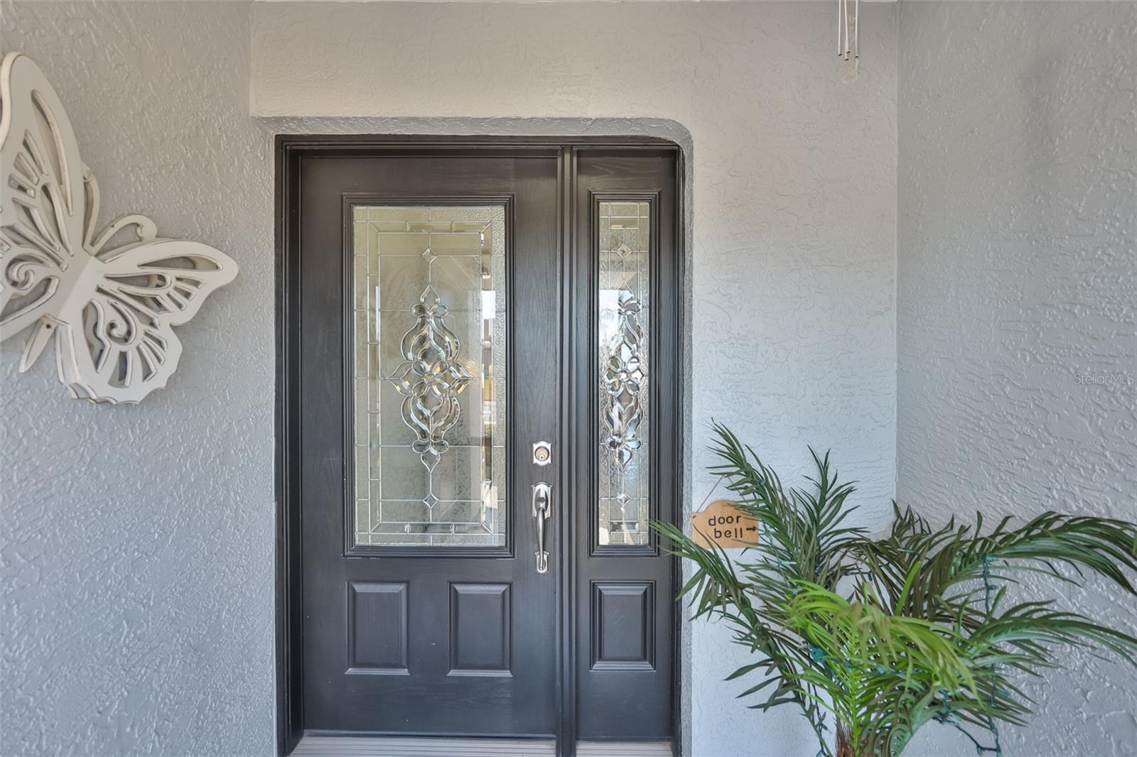 Beautifully glass=leaded front door allows design and function to mingle perfectly.