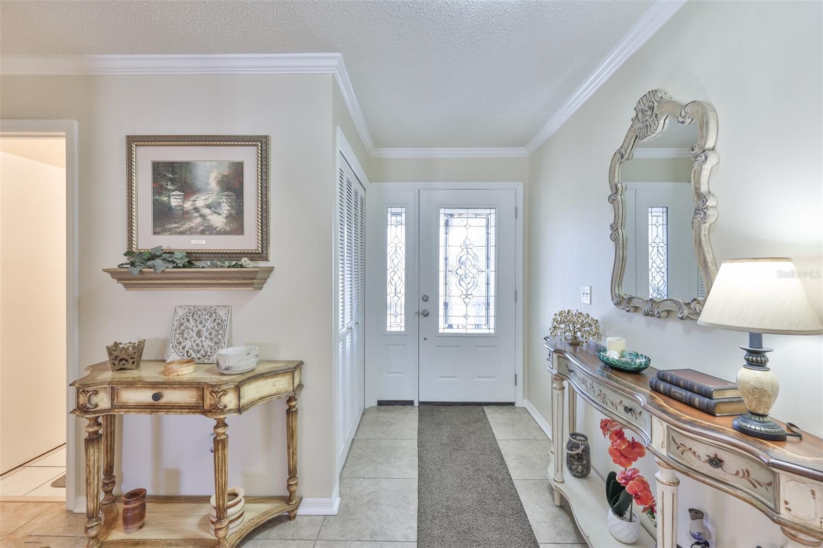 Front front with storage closet and wide entrance the Florida sunshine to come in and filter throughout the space.