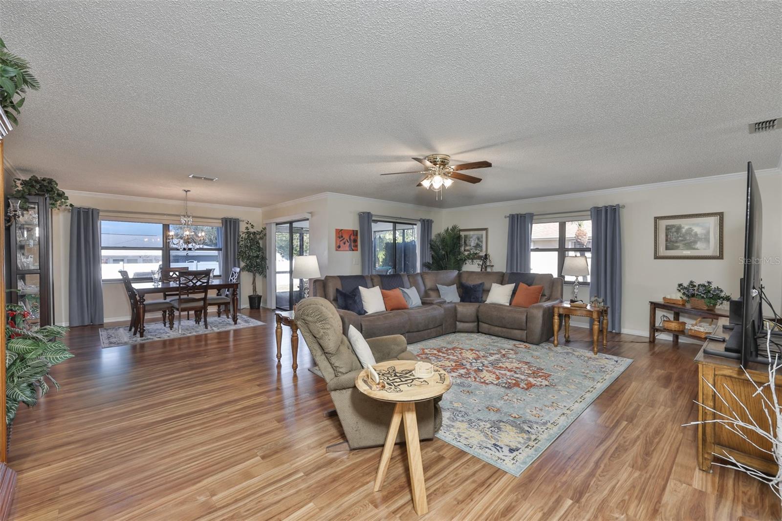As you walk in, you enter an open floor plan boasting of sunshine and beauty.  Notice the large windows and crown molding.