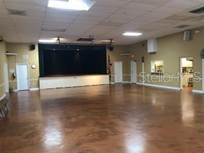 Previous entertainment hall with stage. Please know the clubhouse photos are before the hurricanes and they are being remolded.
