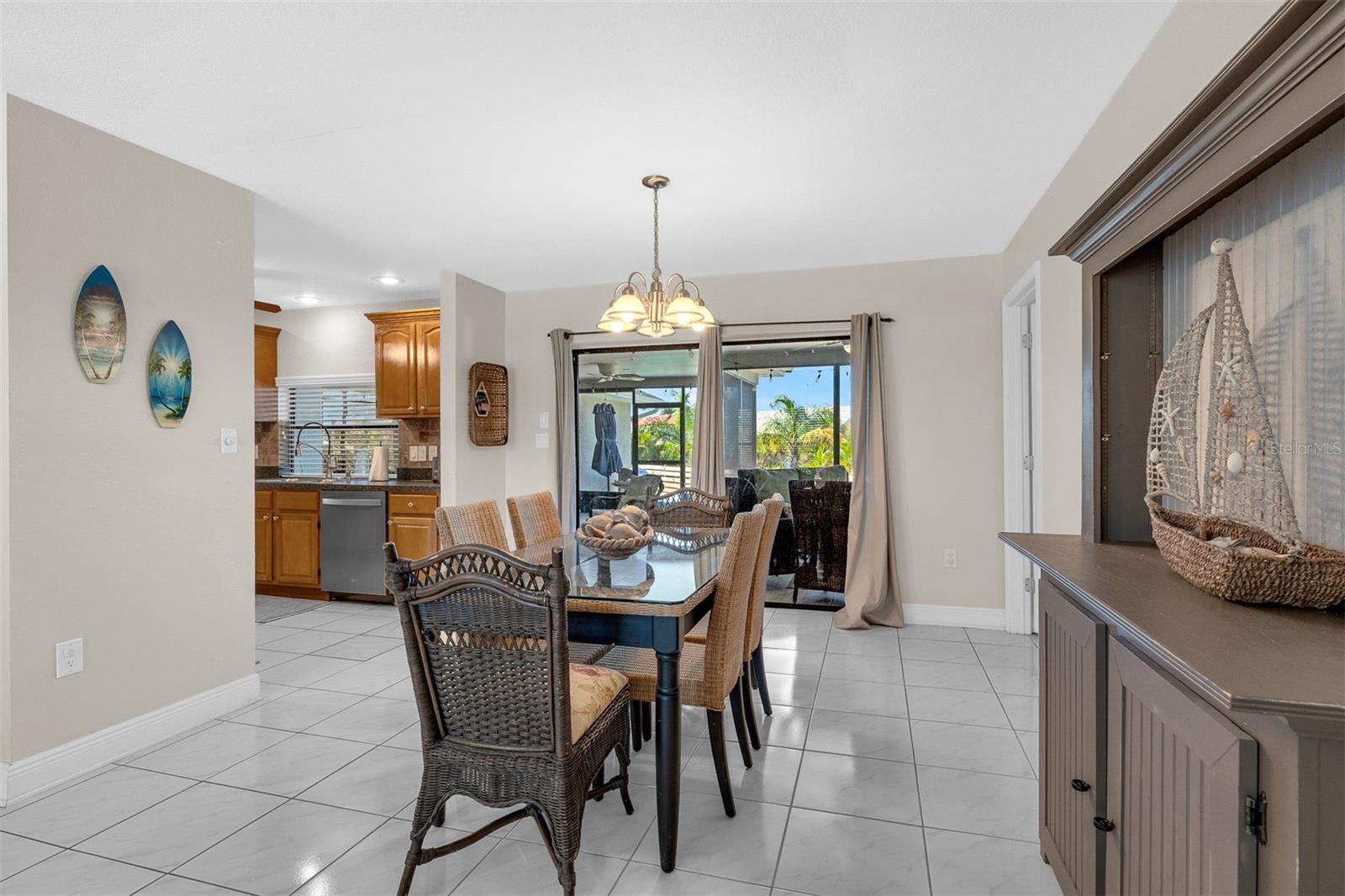 Dining area looking into galley kitchen 9'10: X 10'2" with a passthrough onto the patio/lanai