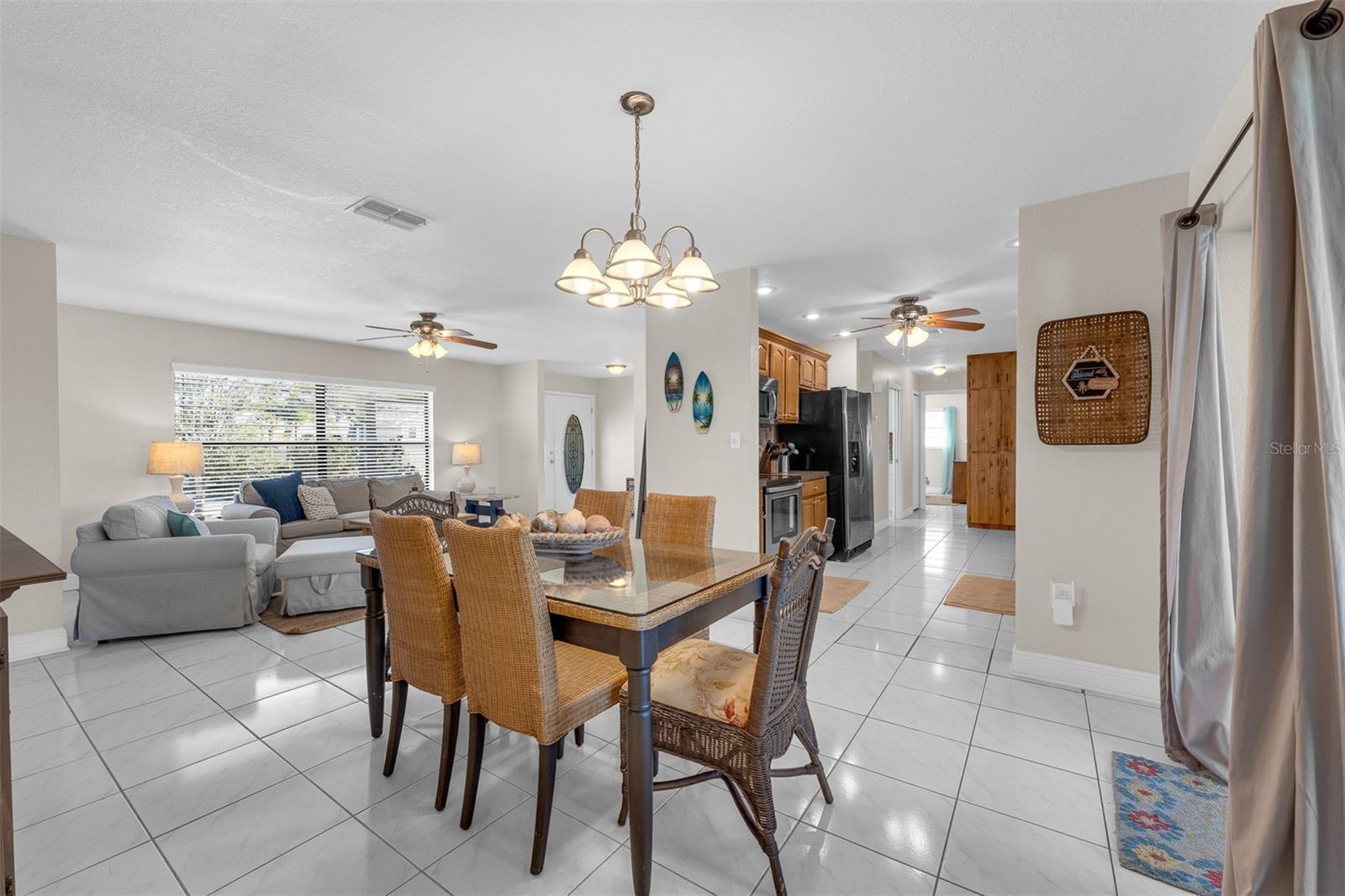 Looking from the primary (master) bedroom side of the house into dining, living area, foyer, kitchen area.
