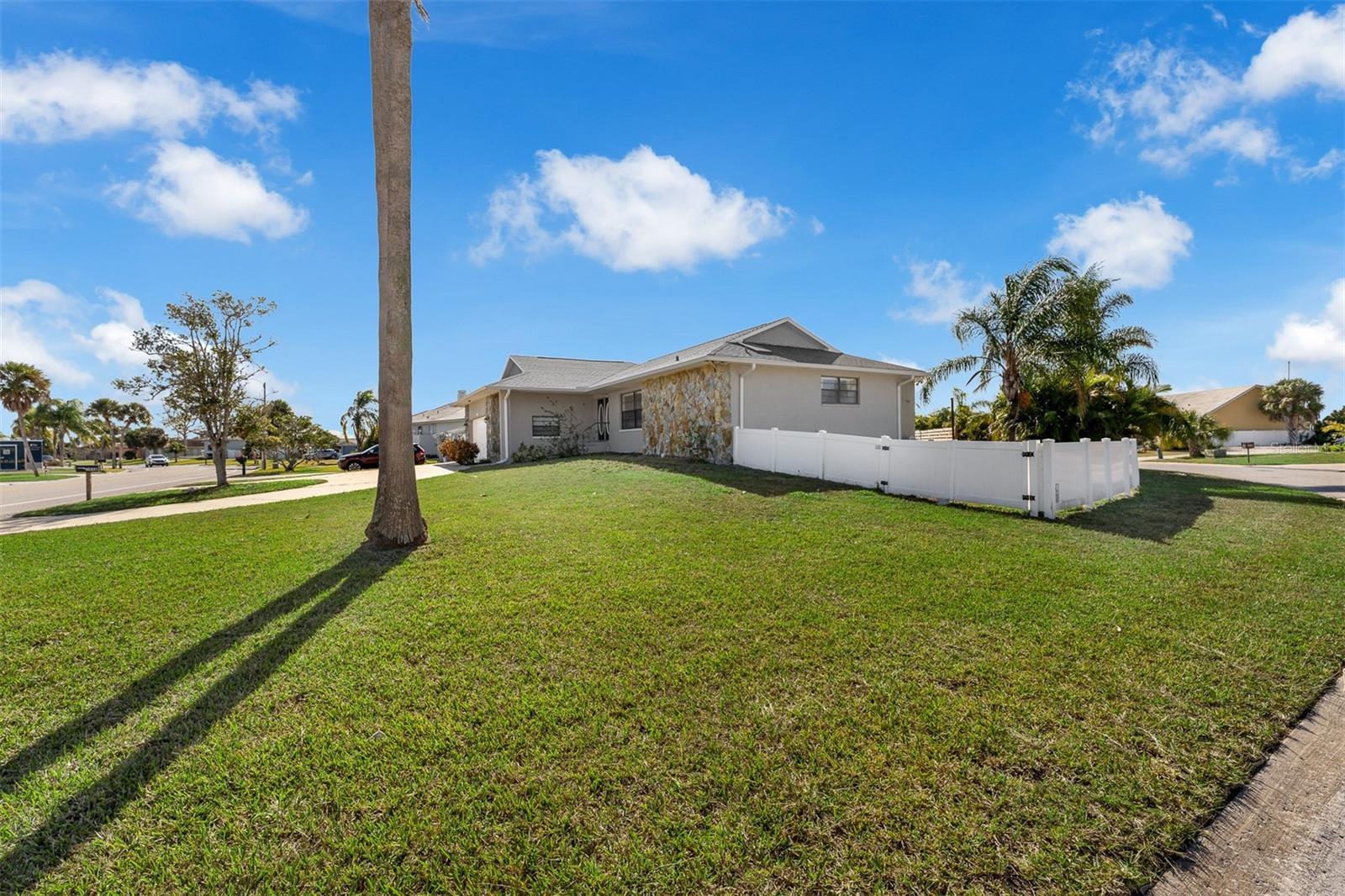 Privacy fenced yard with open pool, screened lanai and mature landscaping.