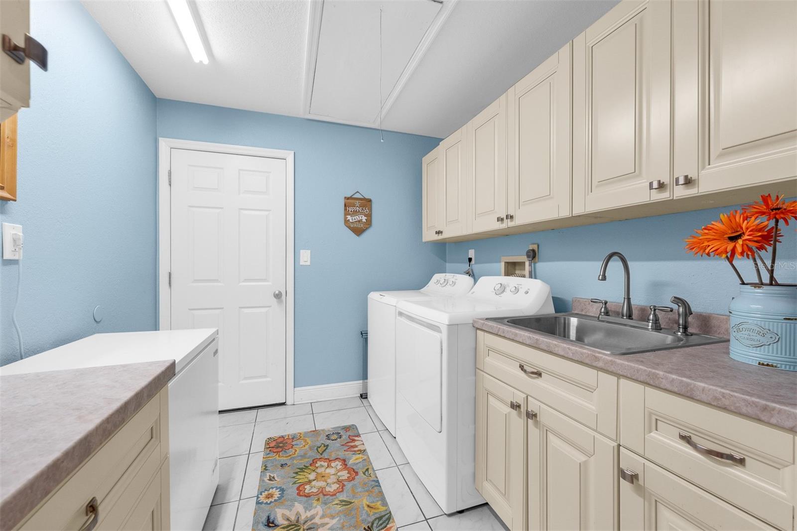 Laundry room 8'2" X 8'7"  leads into attached 2+ car garage