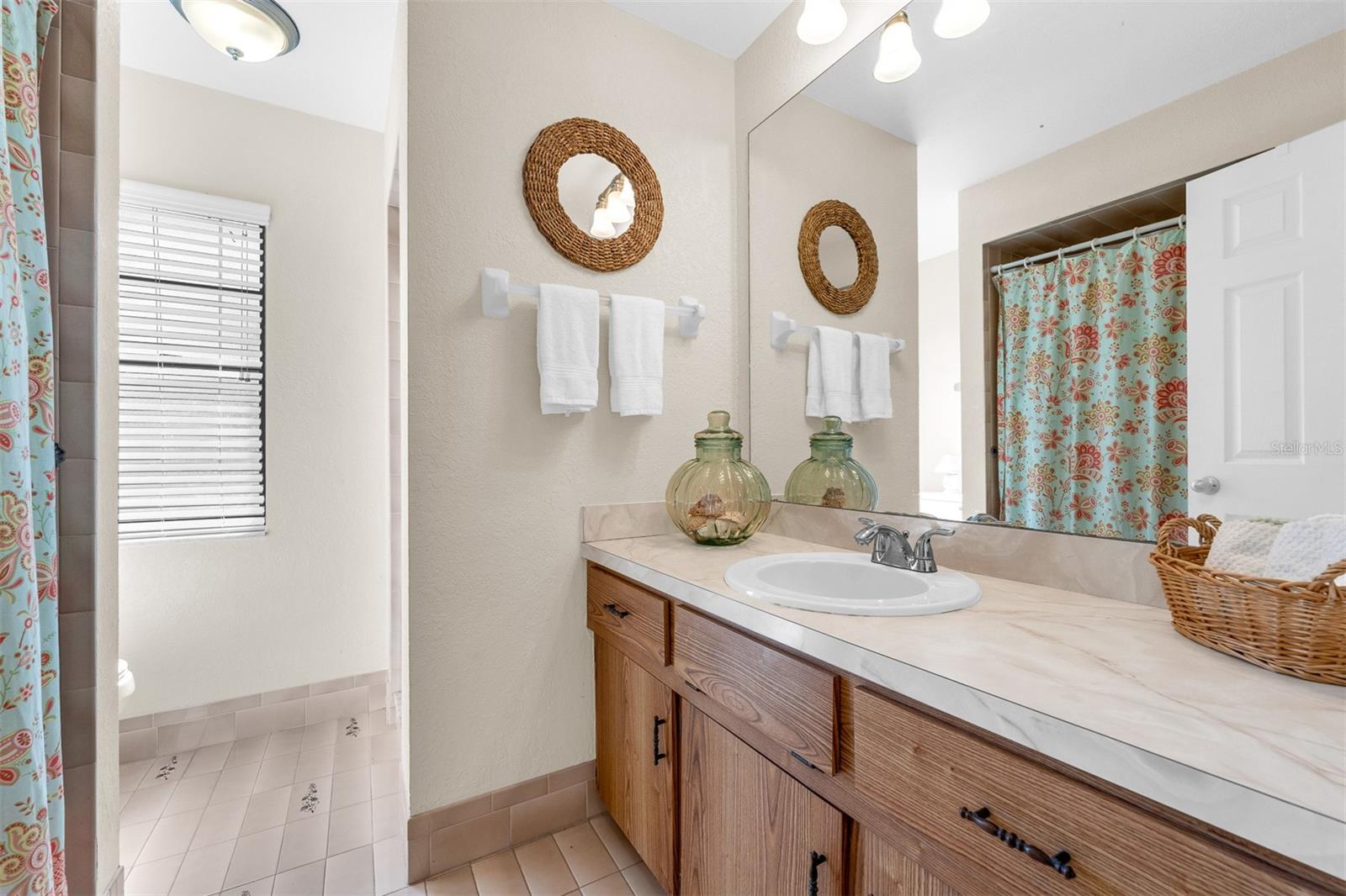 Bathroom #3. 8'10" X 7'10"  Located in hallway between bedroom(s) 3 and 4.  Wood Cabinetry.