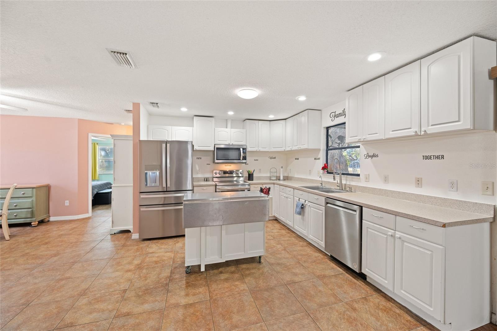 Newer Stainless Appliances ~ Lots of Cabinets ~ Handy Island with Drawers .....and Window over the Sink!