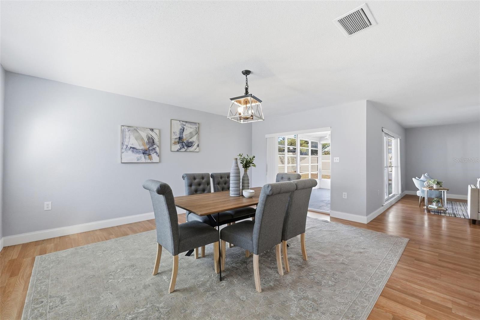 DINING ROOM AND ACCESS TO THE BACK ENCLOSED PATION THROUGH SLIDING DOORS