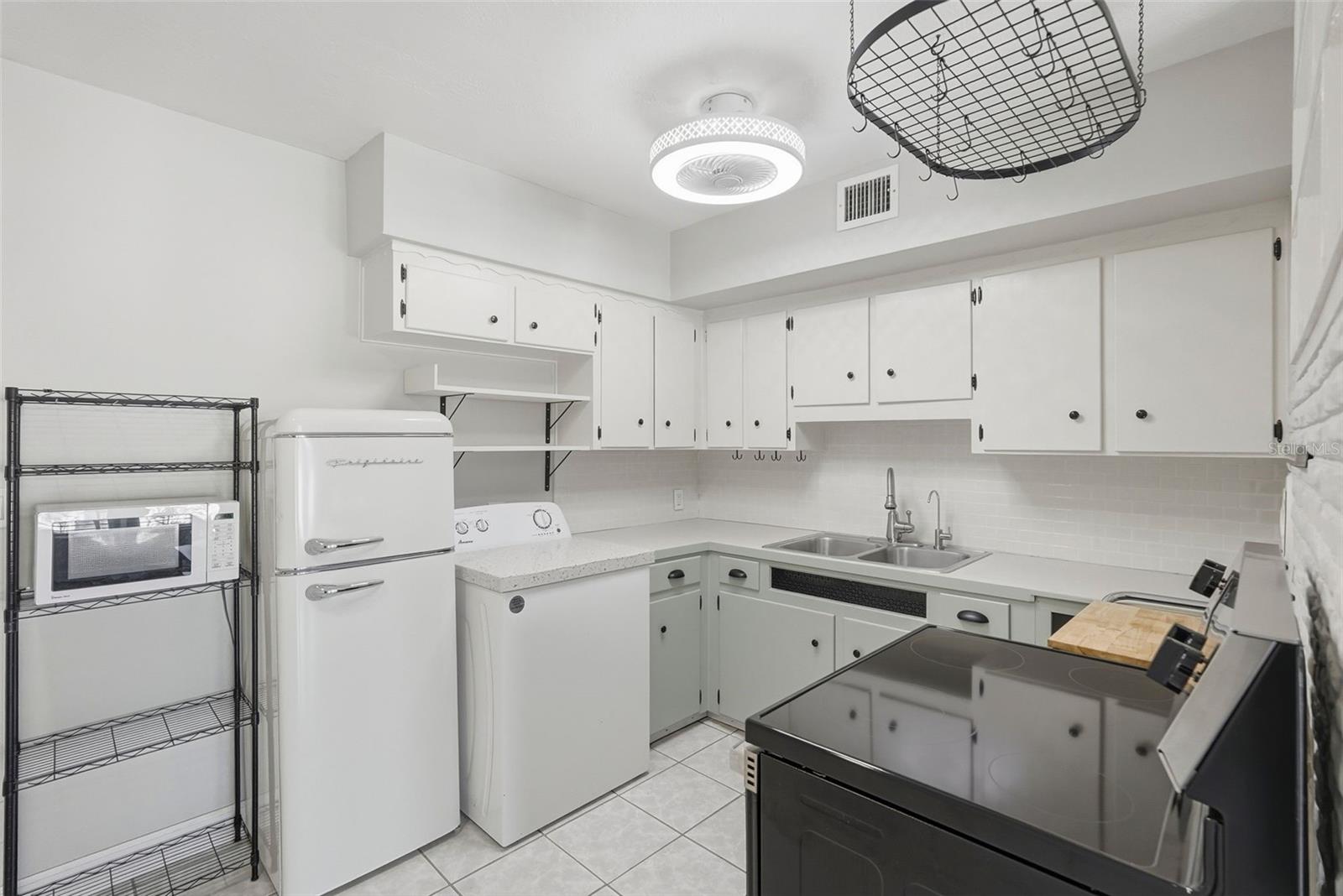 Vintage style refrigerator adds to the charm in this kitchen