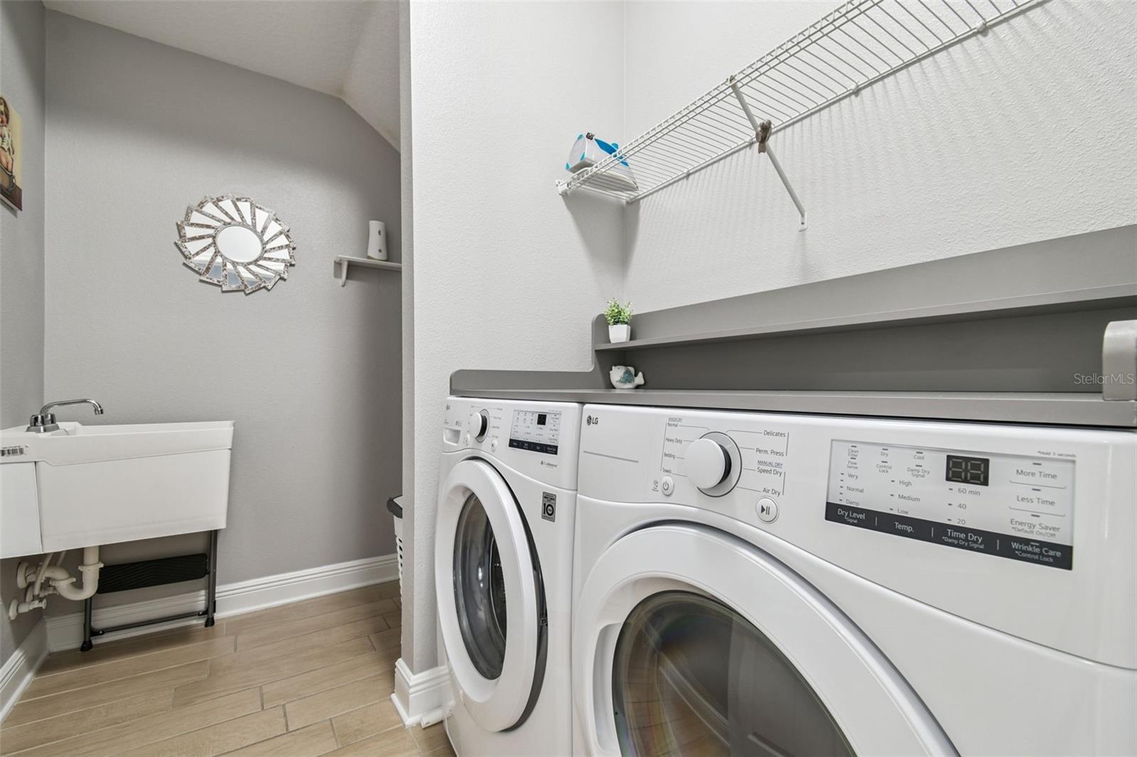 MAIN FLOOR LAUNDRY WITH SHELVING AND EXTRA STORAGE SPACE