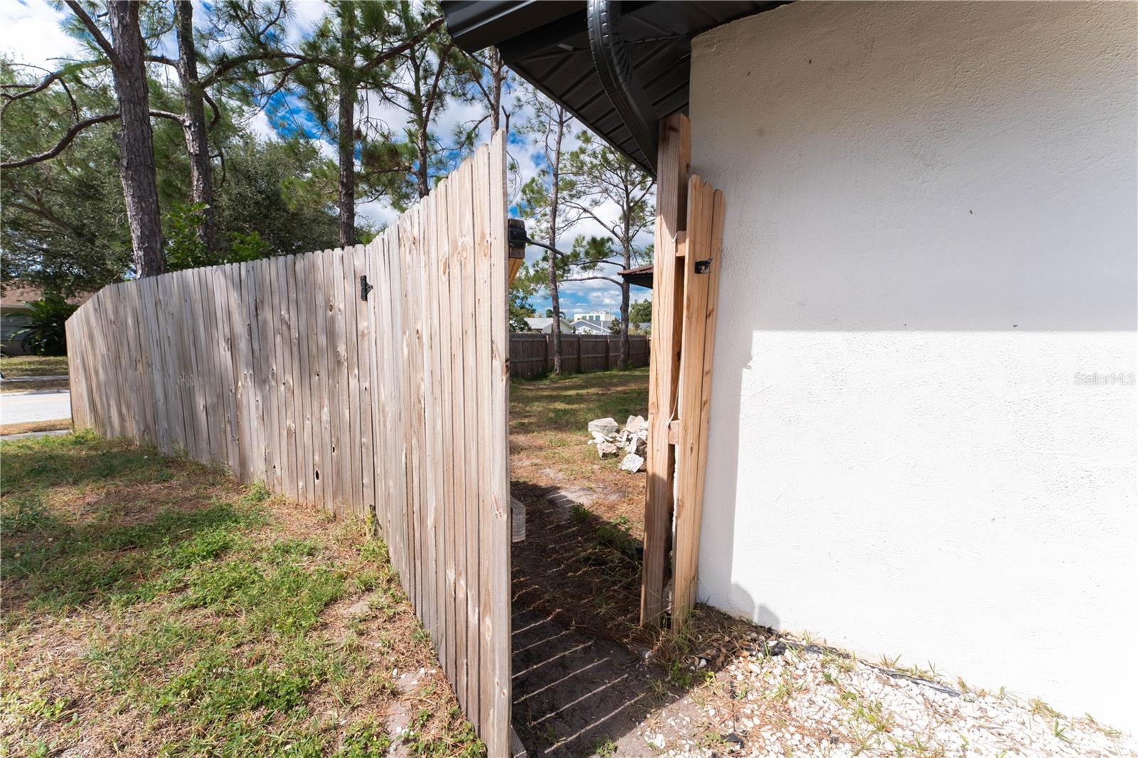 Easy fenced access to side yard from the front of the home.
