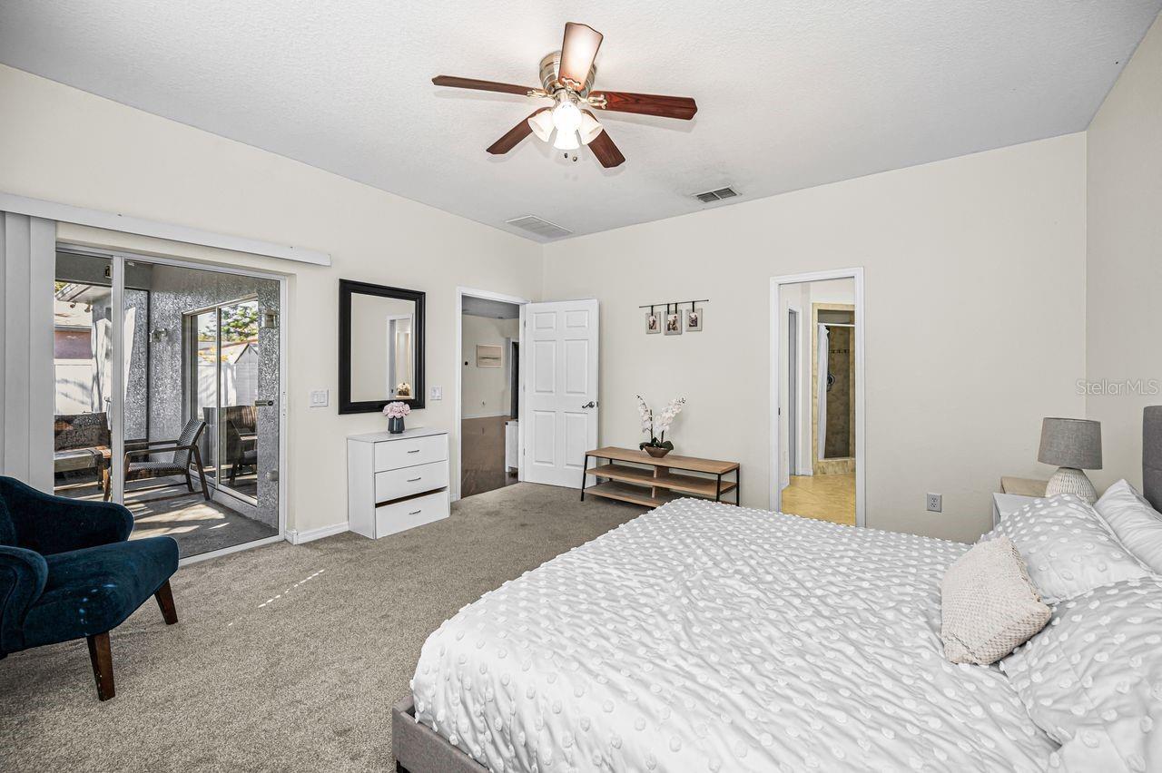 Primary suite also opens to screened-in patio.