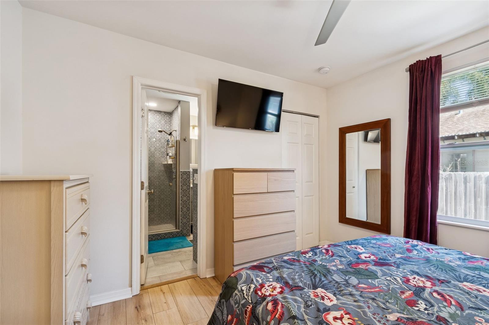 Primary bdrm with door to bath in center of photo