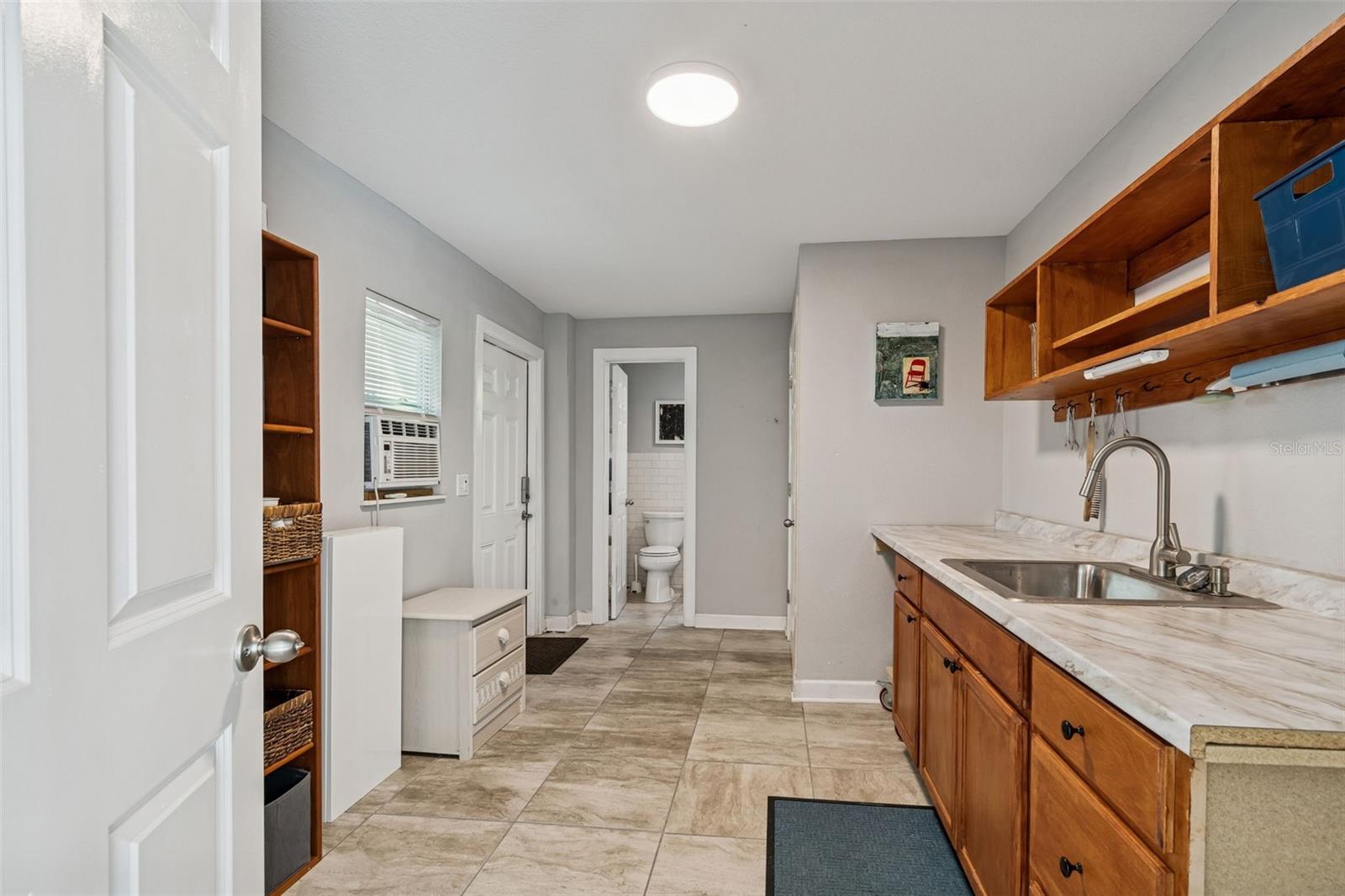 Studio kitchen area. Just needs a frig and range. Door at far end is to the 2nd half bath