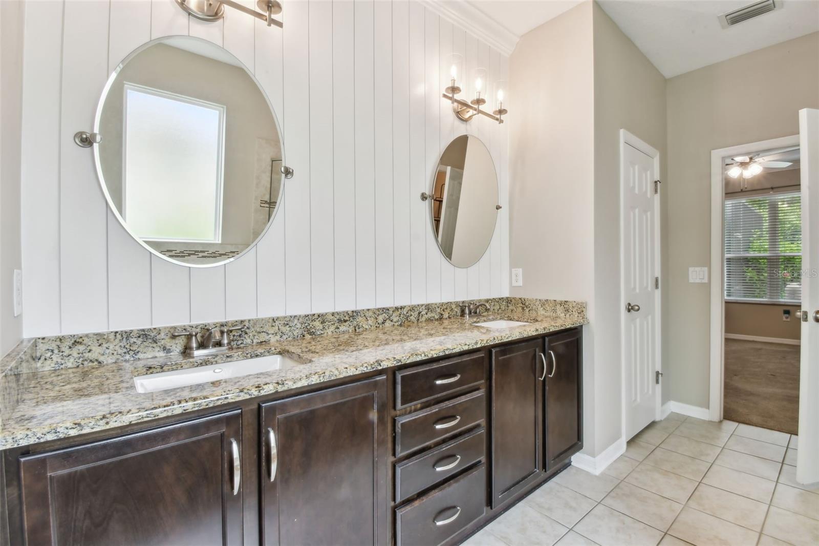 Dual vanities, granite counters & ship-lap accent wall