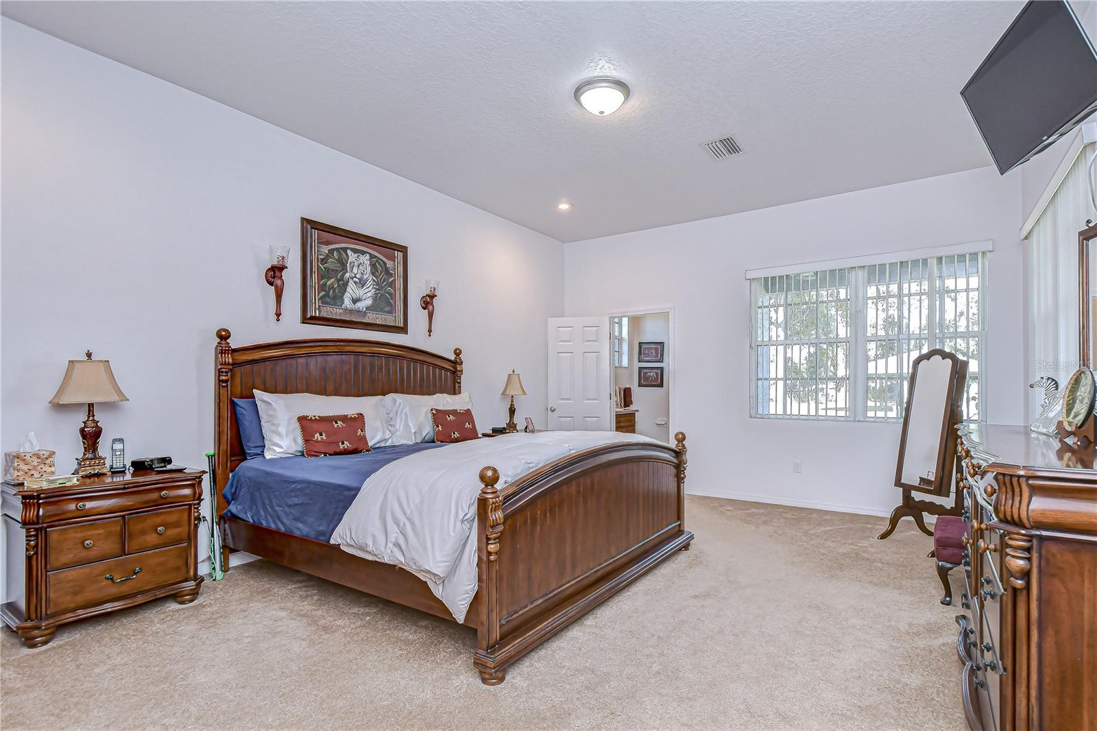 Primary bedroom with carpeting, and wide windows for abundant natural light!