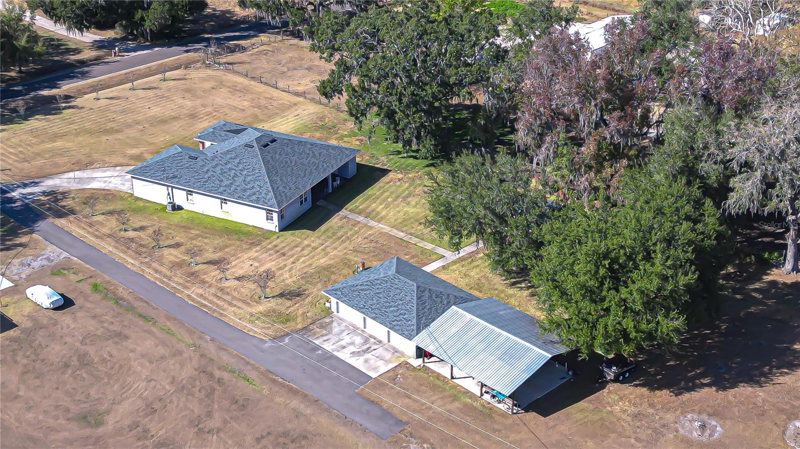 Sprawling homesite with mature trees, and paved drive access!