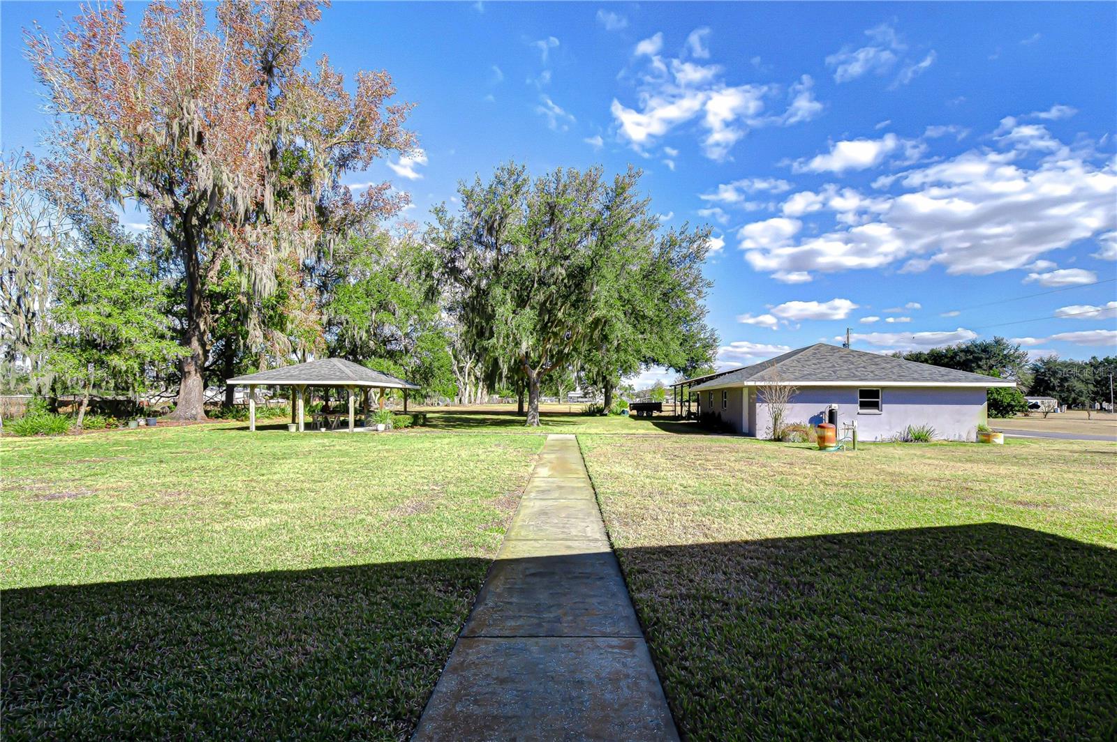 Wide open backyard with covered gazebo with 2025 new roof, and mature shade trees!