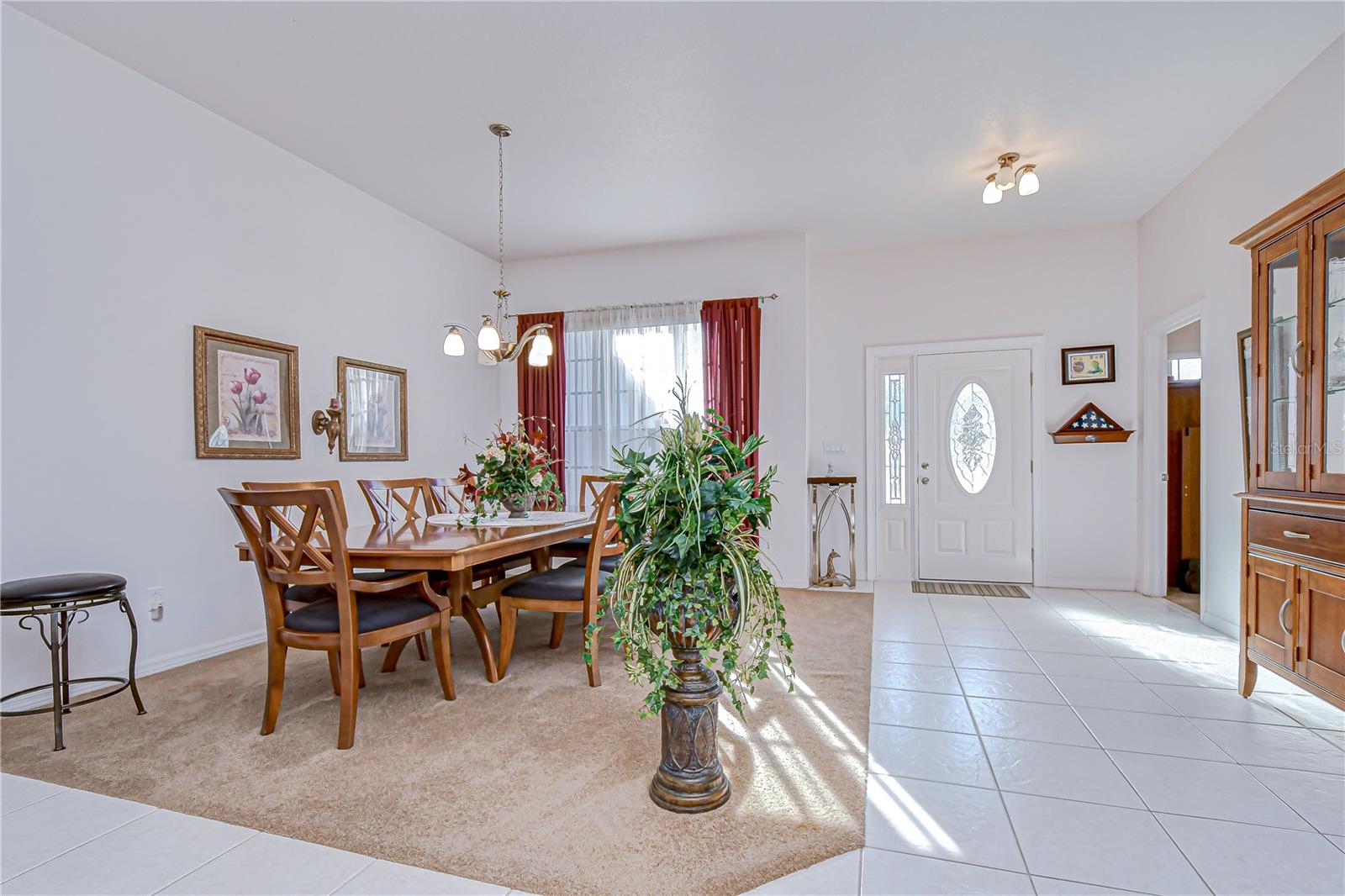 Airy dining area with soaring ceilings, abundant natural light, and a welcoming entry!