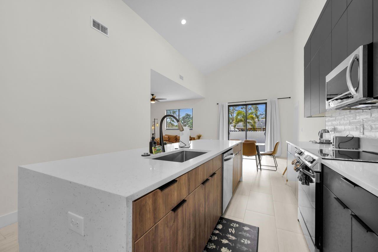 Kitchen boasts an amazing island with a solid surface waterfall edge