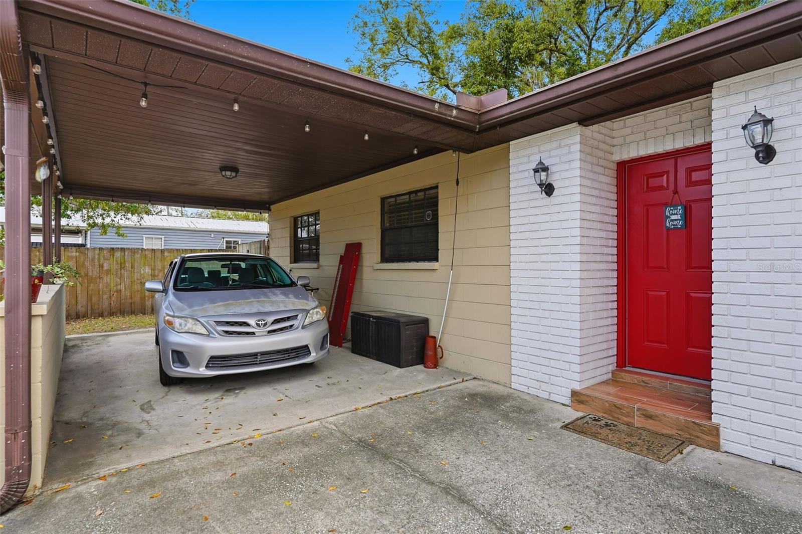 Over sized carport, Could be used for a private front patio and or additonal storage for the toys!