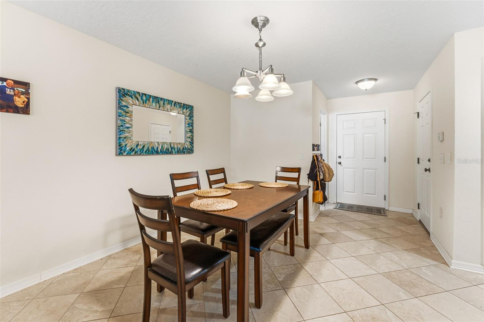 Dining area with entry door, garage door to the right and half bath  to the left