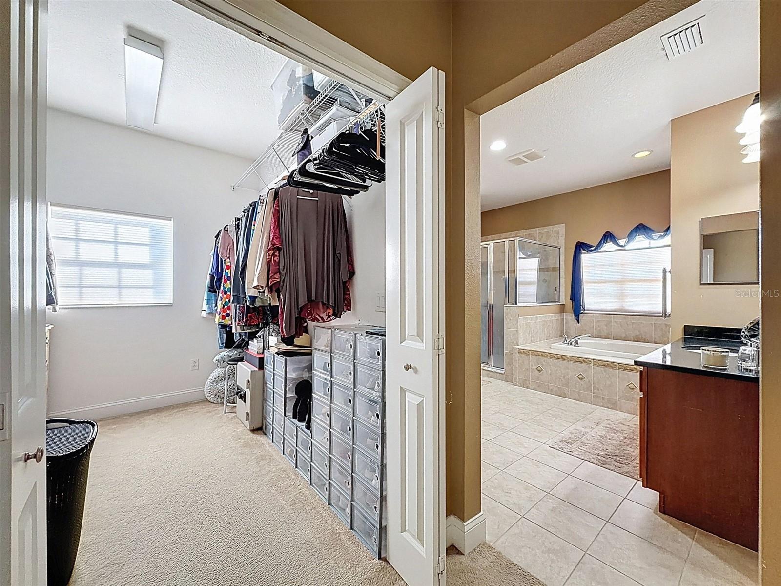 Primary ensuite walk in closet and bathroom