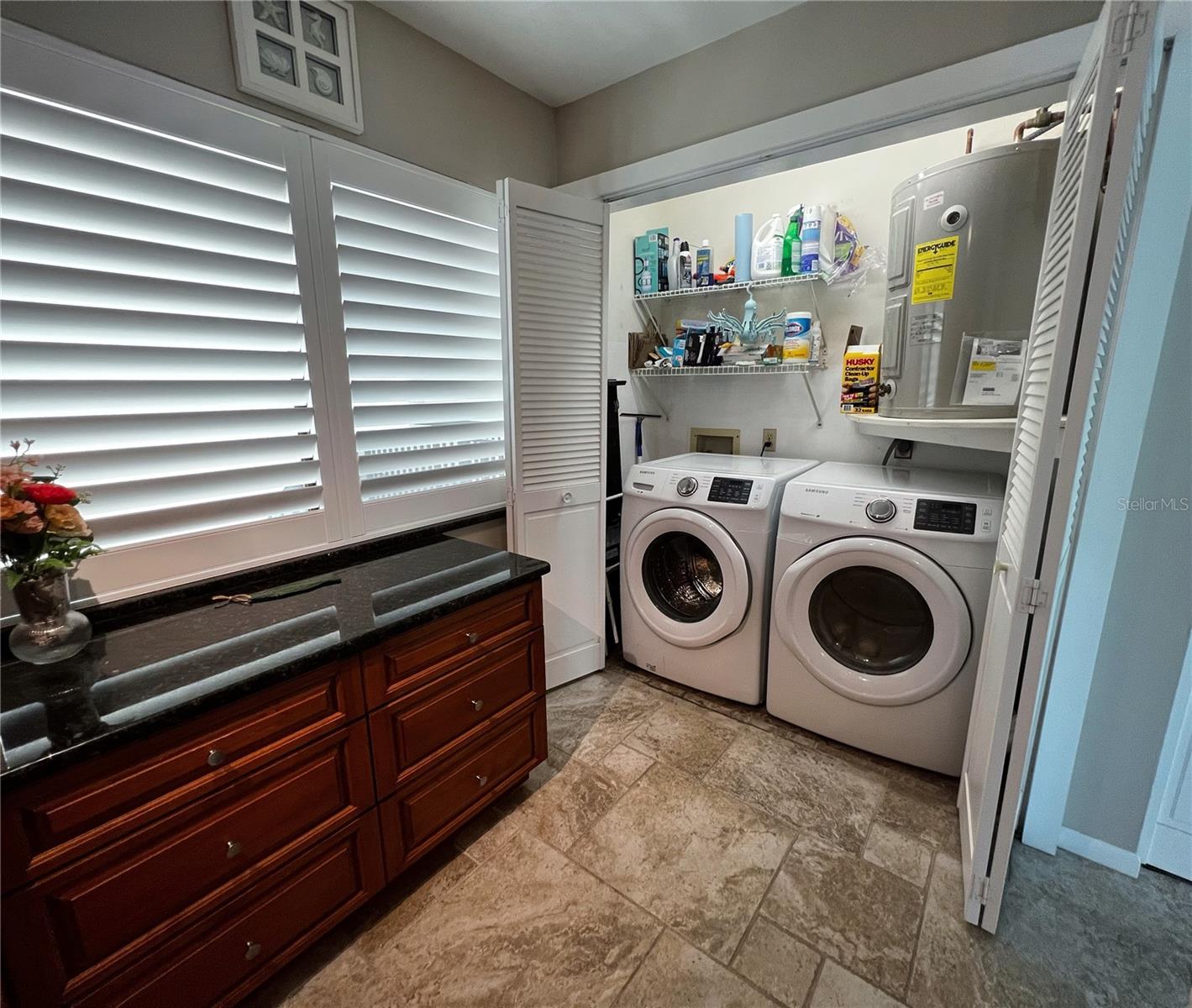 Full washer and dryer closet in the kitchen plus storage space.