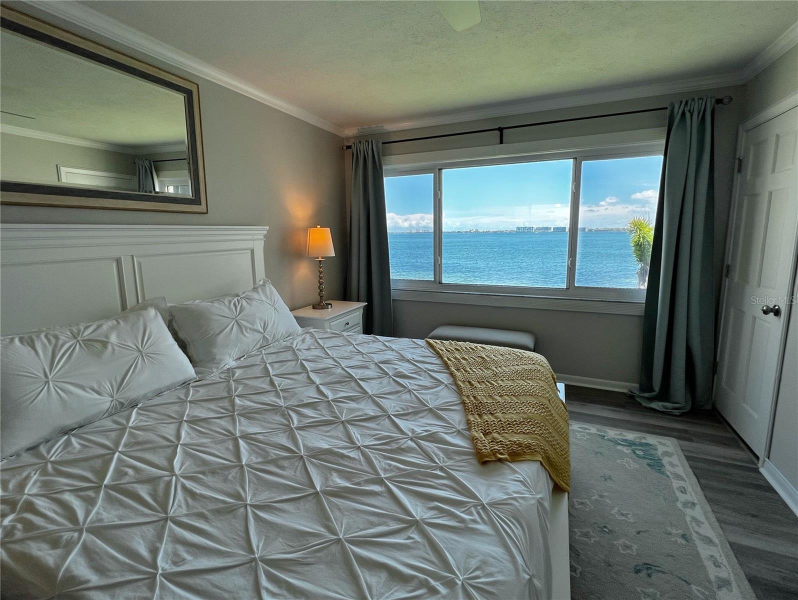 Water views from bed- a large picture window in the primary bedroom.