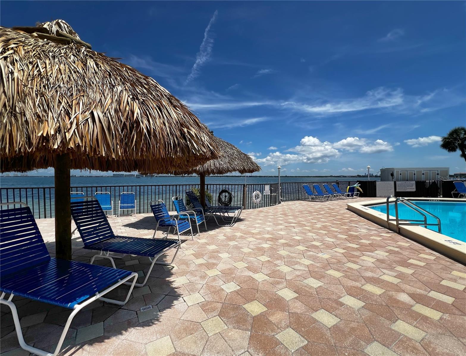 Plenty of space to lounge and tan around the waterfront pool and hot tub.