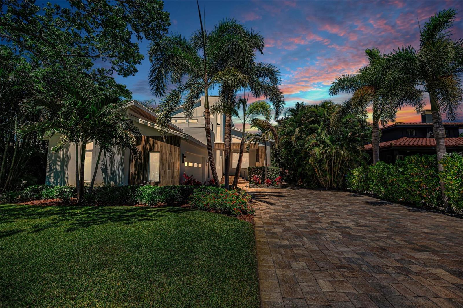 Lush tropical landscaping a stately paved driveway will welcome you home each time.
