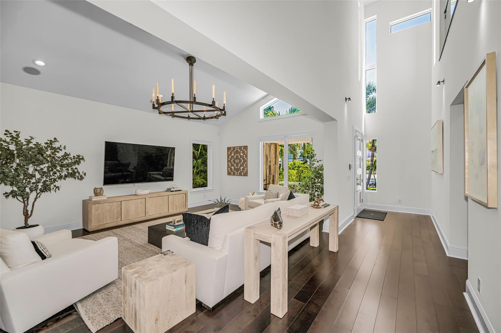 Rich flooring, dramatic vaulted ceilings, and an abundance of windows  flood the interiors with natural light.