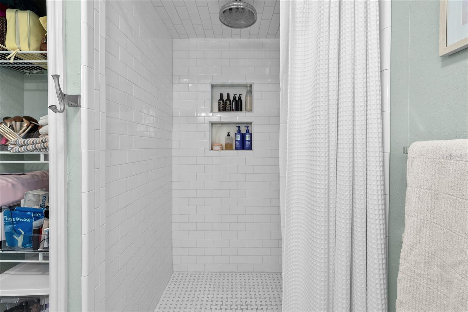 master shower with rainbird and linen closet