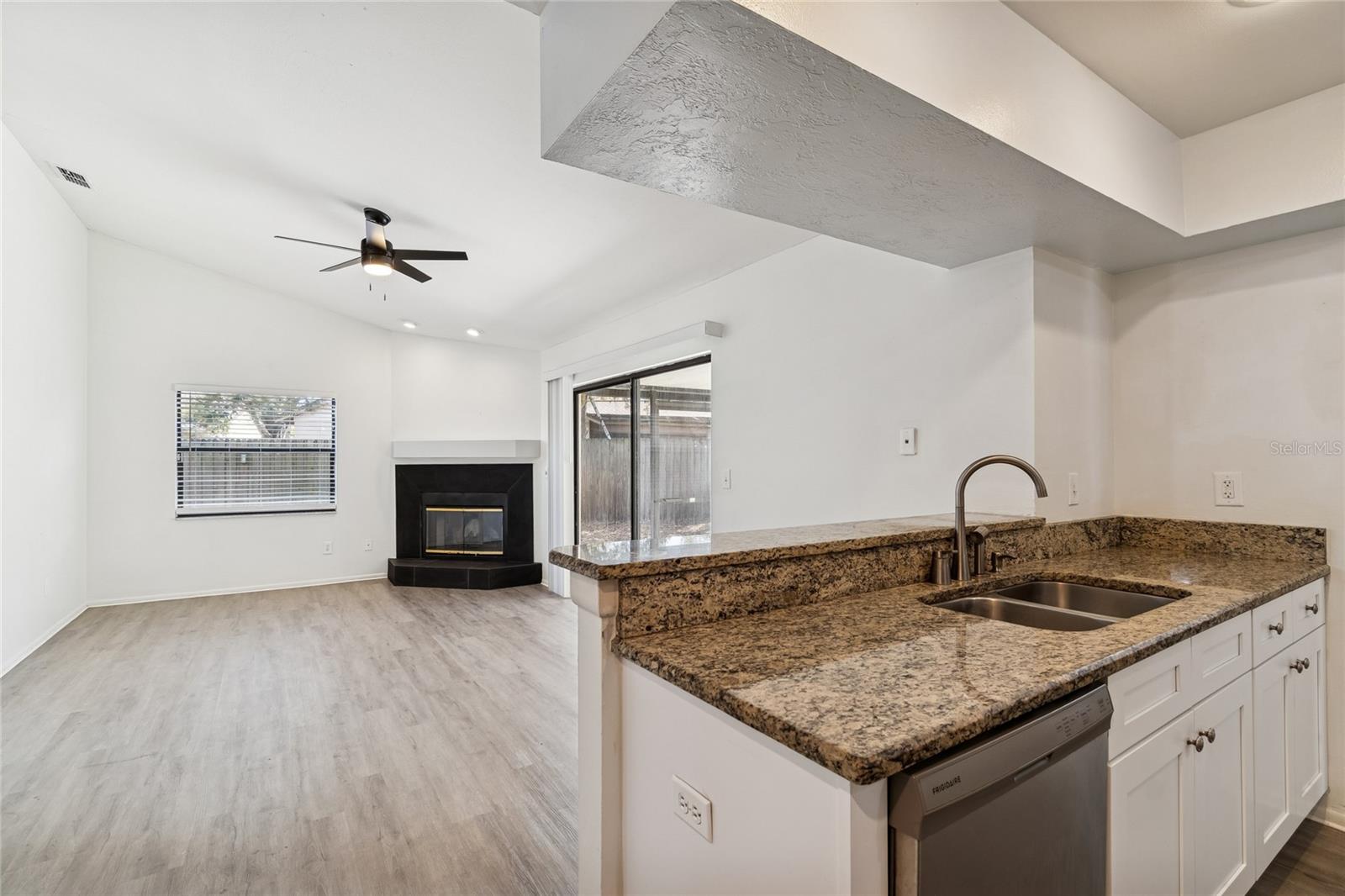 FAMILY ROOM WITH FIREPLACE FROM KITCHEN
