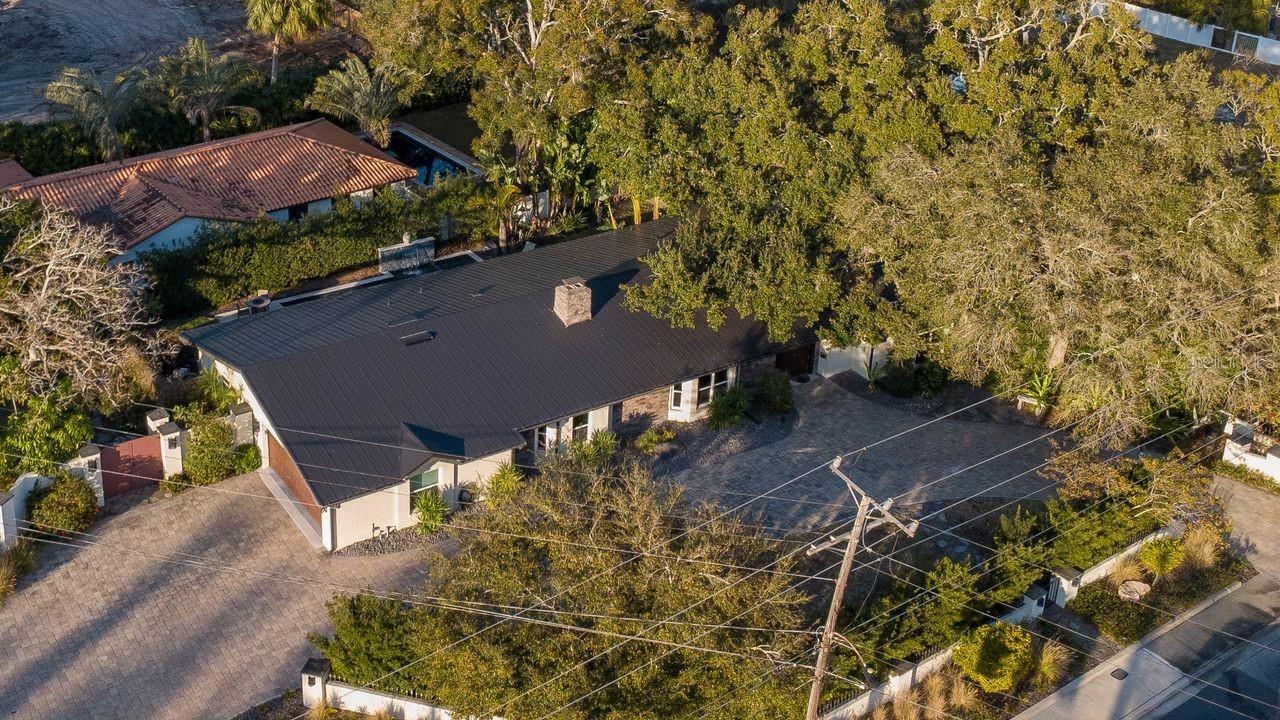 Aerial of home reflecting circular driveway and sidecar garage
