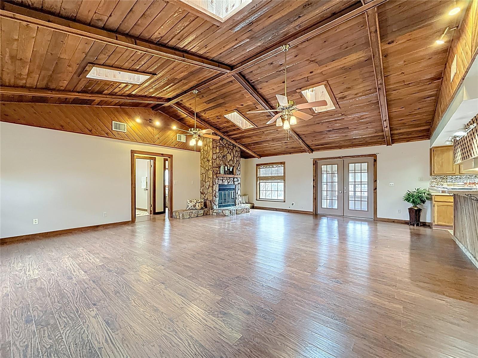 Cathedral cedar wood ceiling, working fireplace (wood converted to gas) 30'4" x 21'9" and open floor plan with 4 seat breakfast bar open kitchen and enclosed family room