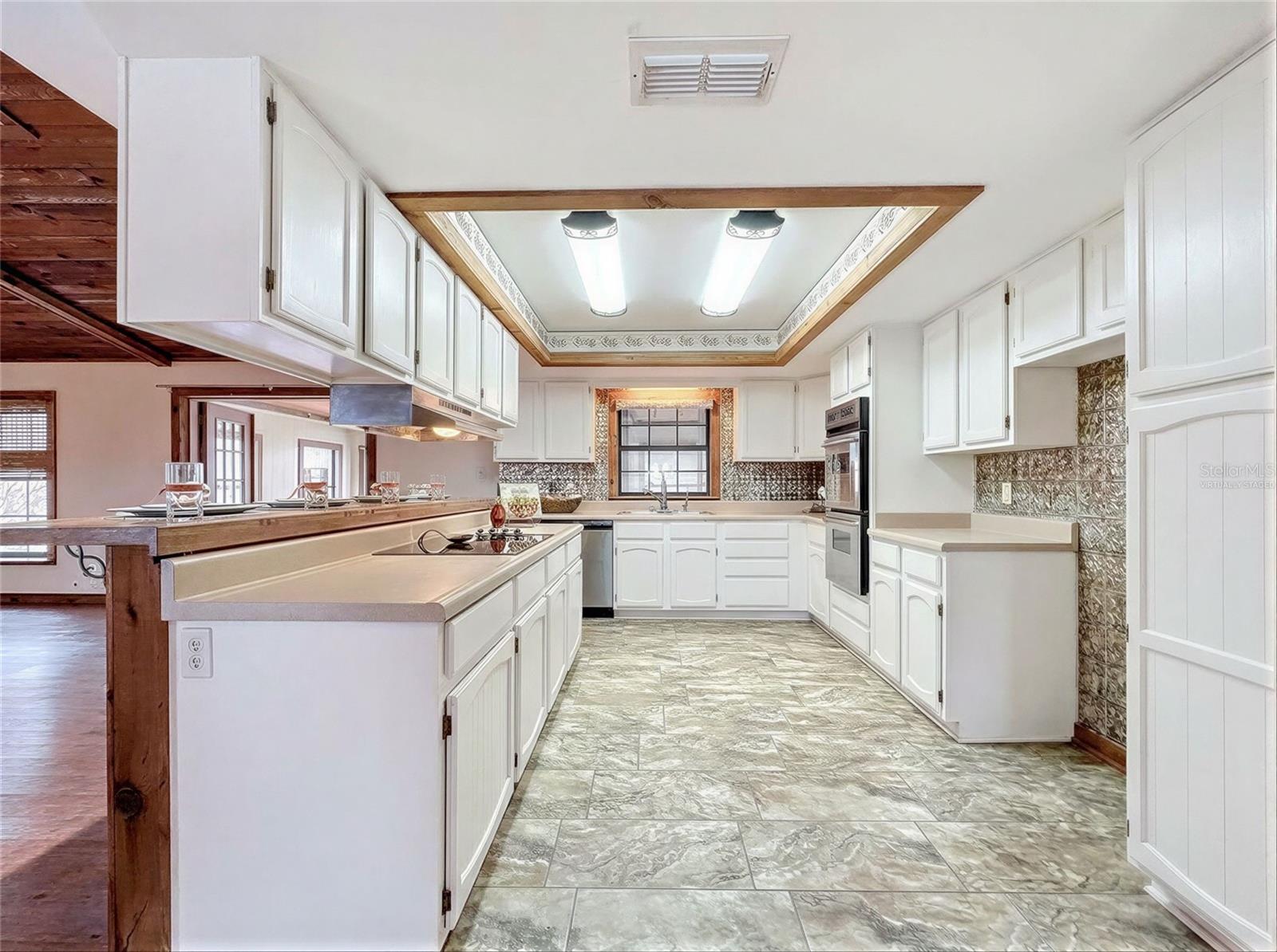 Virtually staged kitchen showing white paint option
