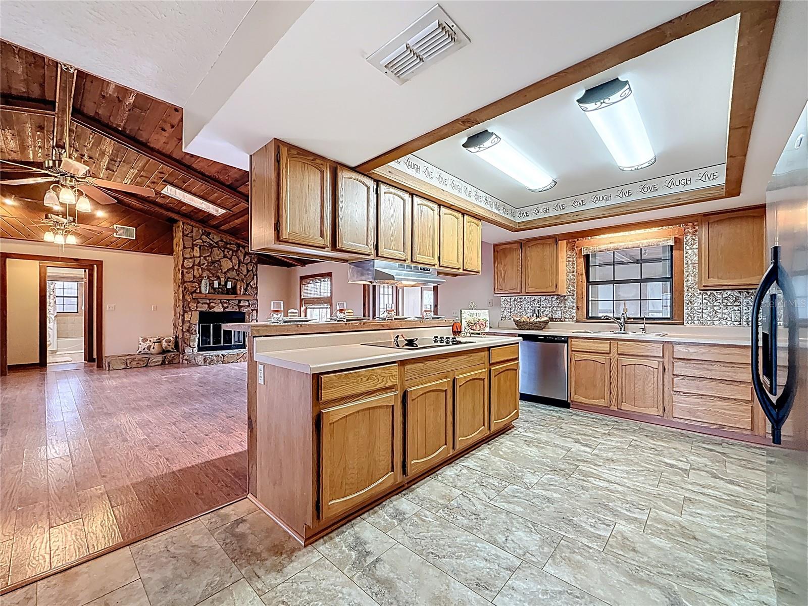 Open kitchen design with breakfast bar, cook top, RO water system, dishwasher, fridge and double oven