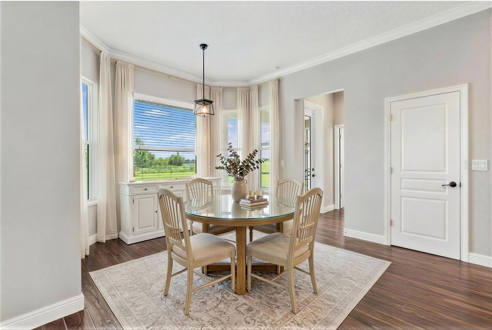 Dinette area virtually staged overlooks pool and backyard