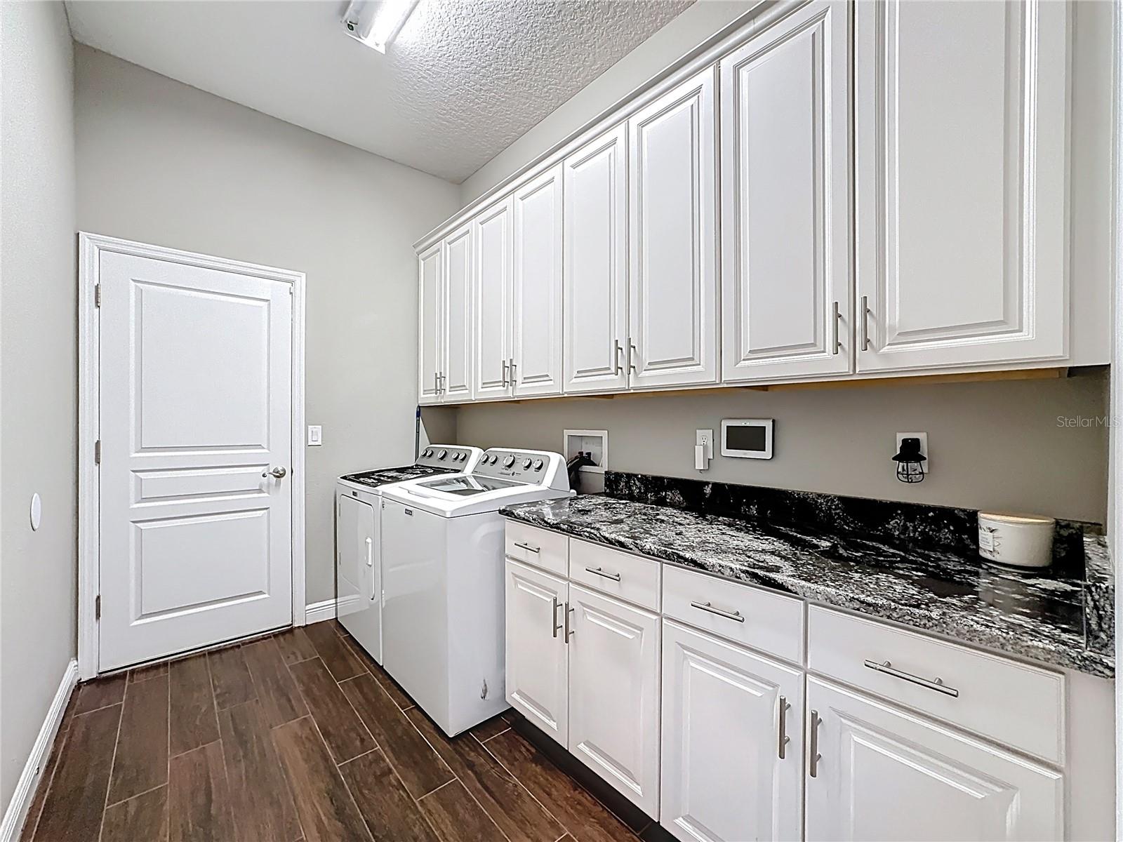Inside Laundry room with LOTS of Counter Space and Cabinets