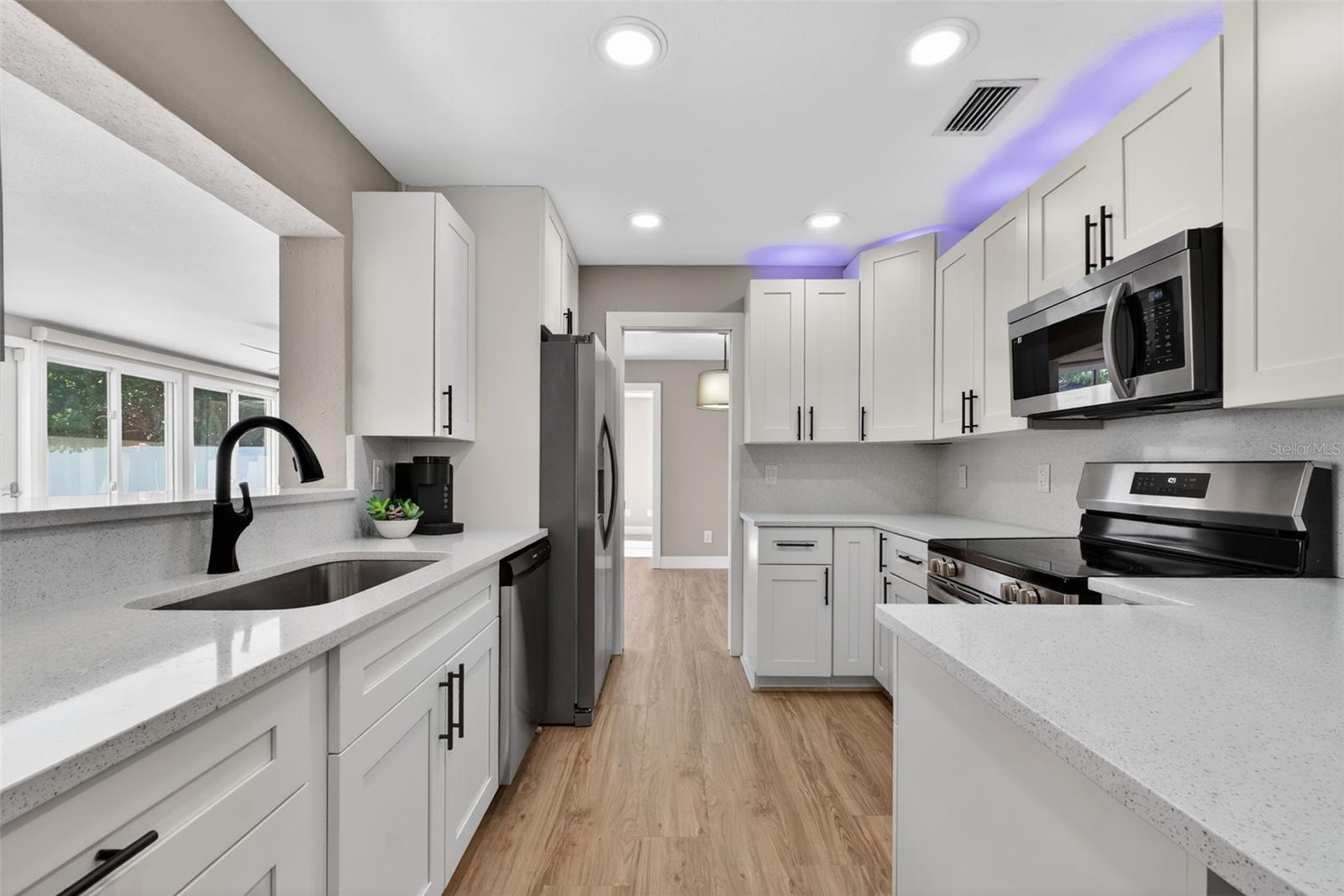 NEW 2025 kitchen with stainless steel appliances and new LVP flooring thoughout.