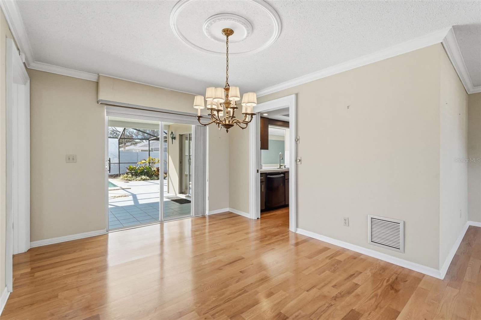 Dining Area overlooking Lanai/Pool with Pocket door to Kitchen