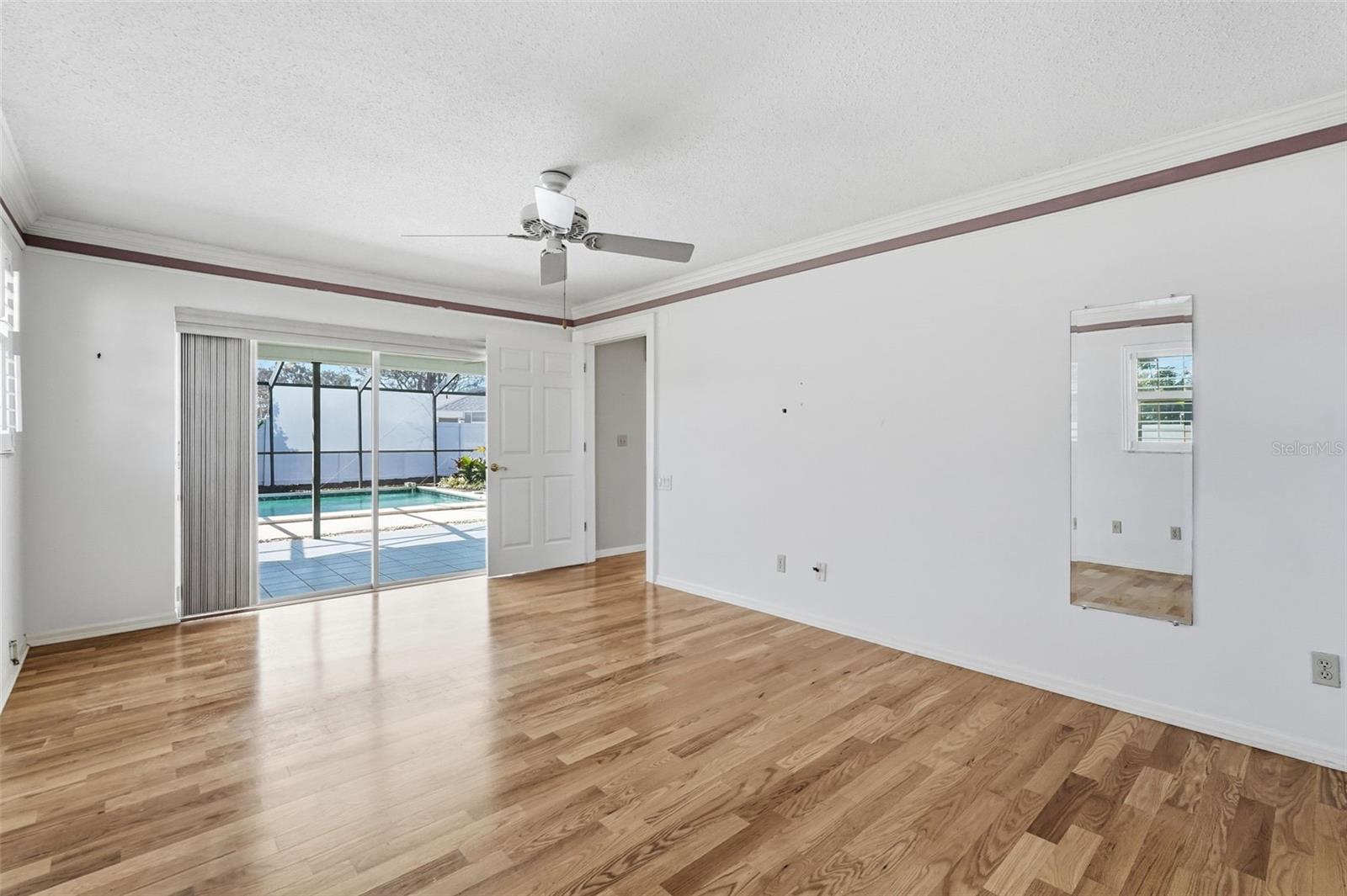 Primary Bedroom overlooking Pool & Lanai