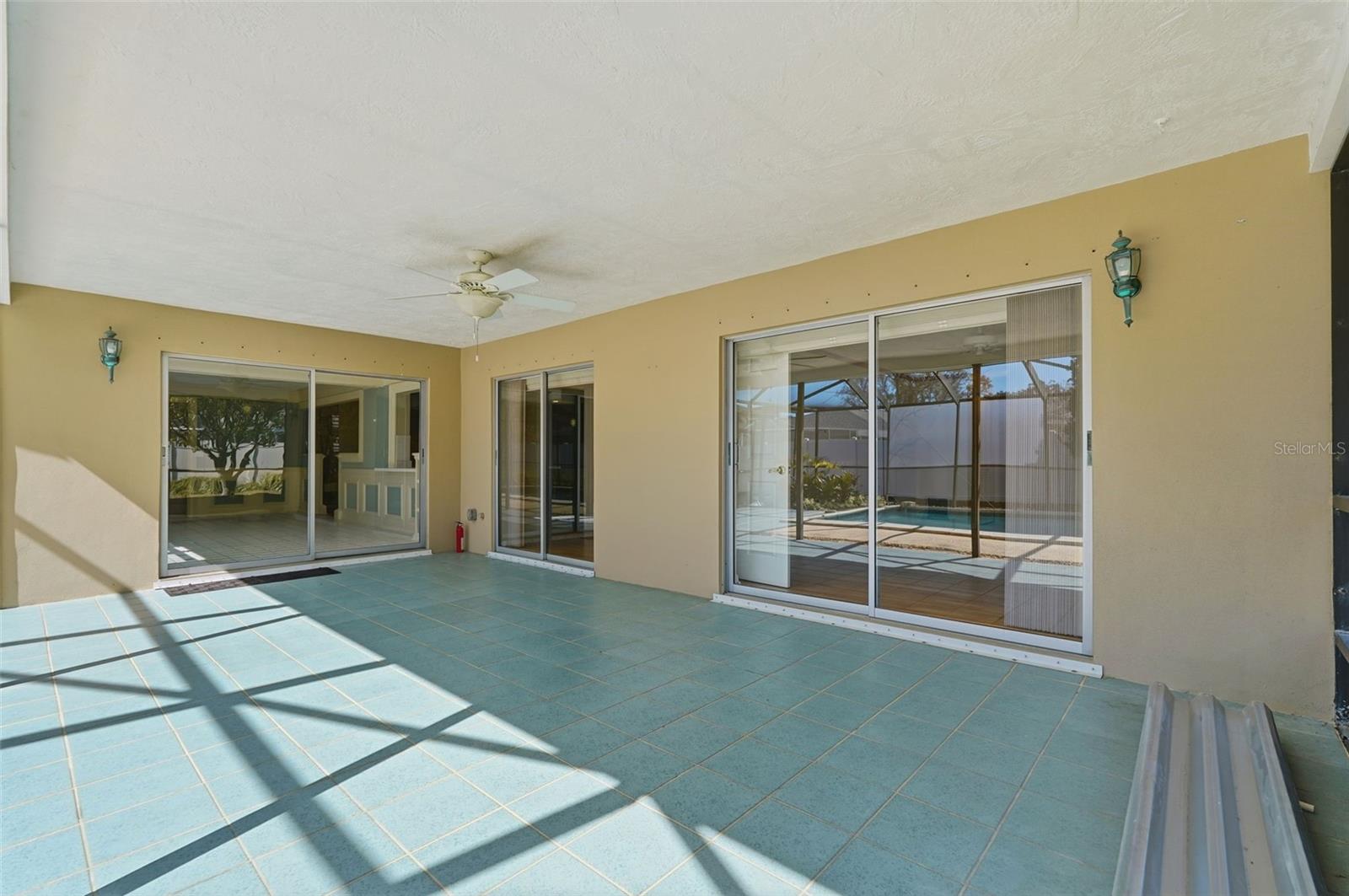 Huge covered screened Lanai overlooking pool with hurricane panels for all sliding doors