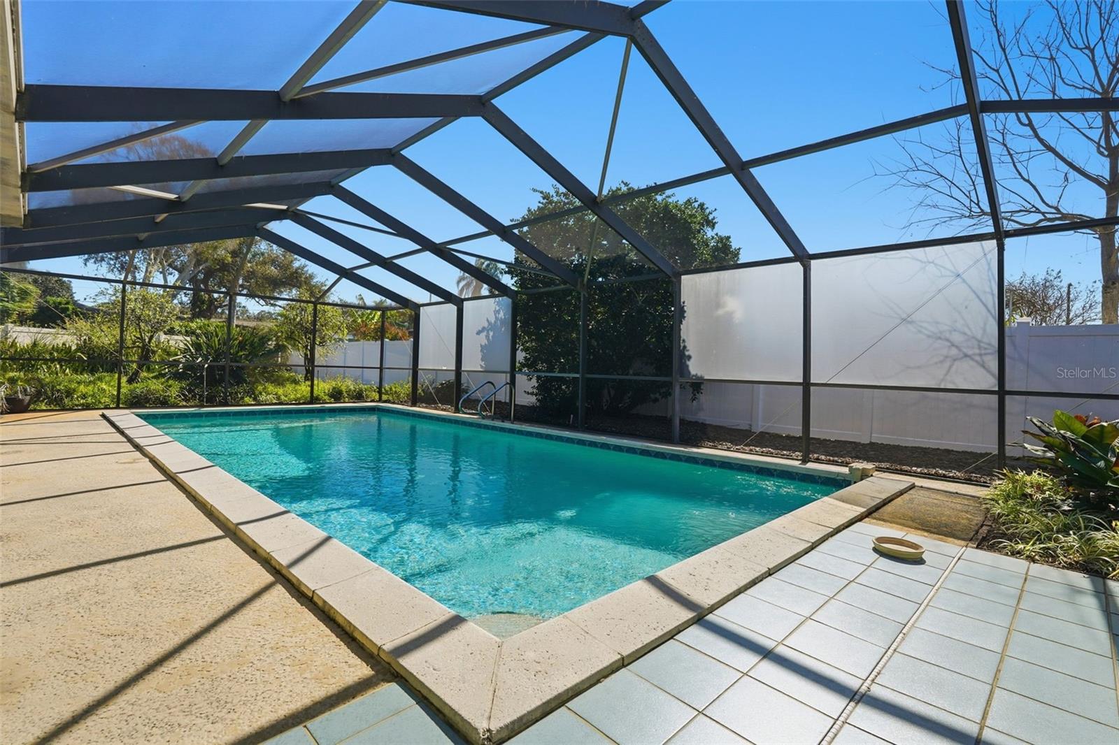 Beautiful 32 x 15 Screened in Pool with privacy screens across back