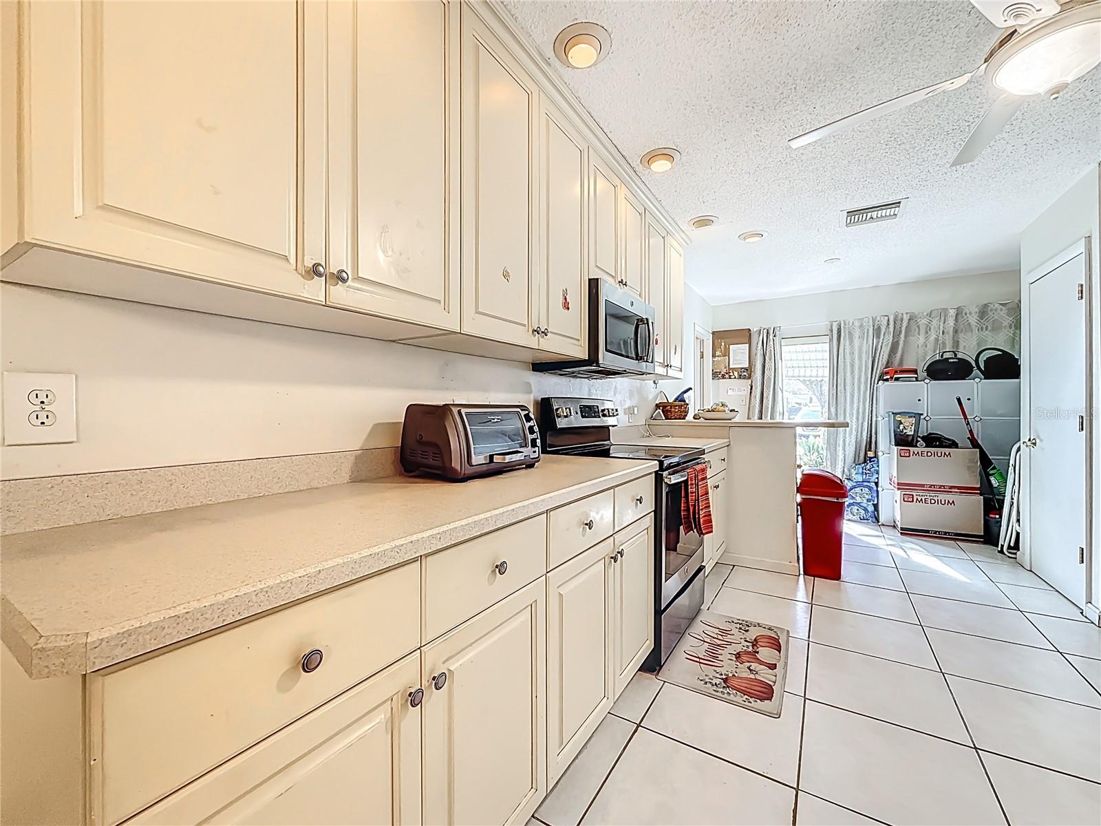 1020 85th Ave N no 119, kitchen, view toward back slidrs and patio garden area