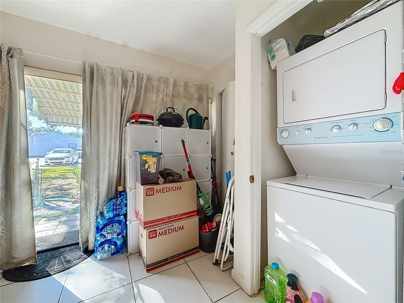 1020 85th Ave N no 119, Laundry closet, view of sliders to back patio and garden