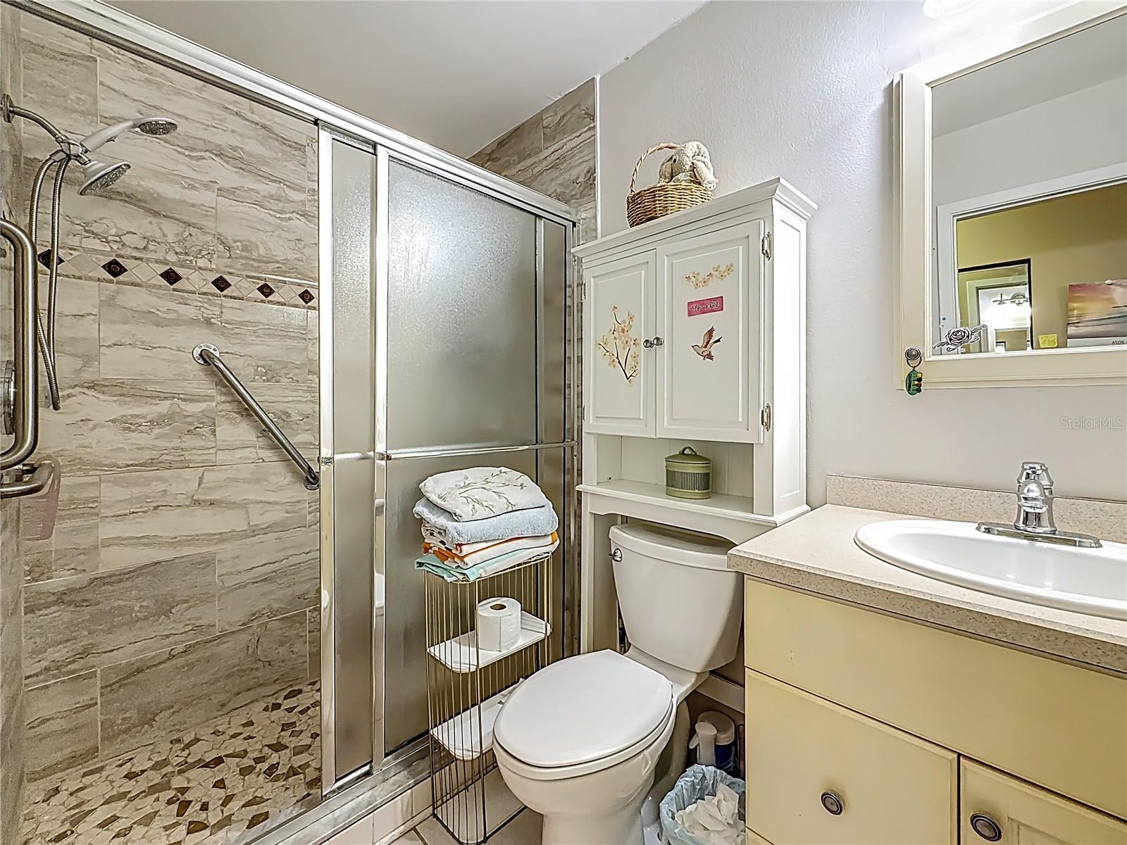 1020 85th Ave No no 119, primary bedroom ensuite bath, walk in shower with newer tile