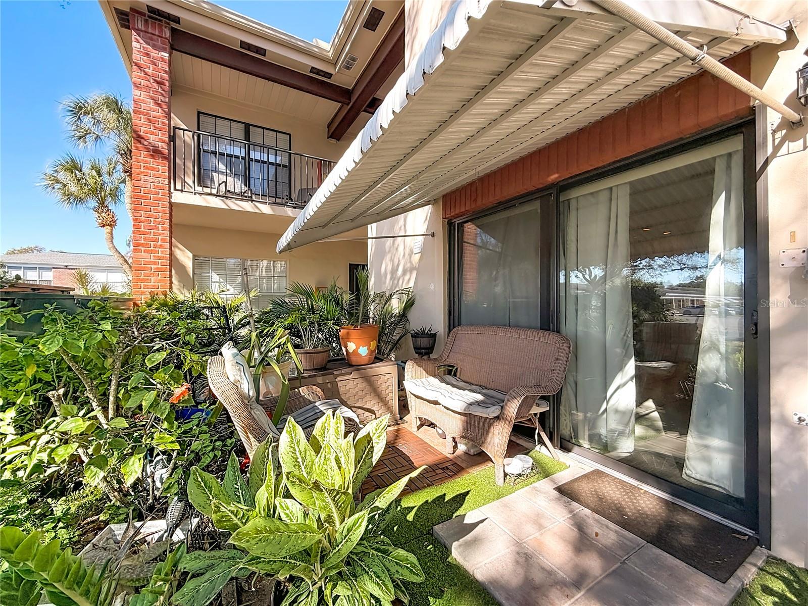 1020 85th Ave N no 119, back patio and garden, large awning provides shade and can be used for storm protection