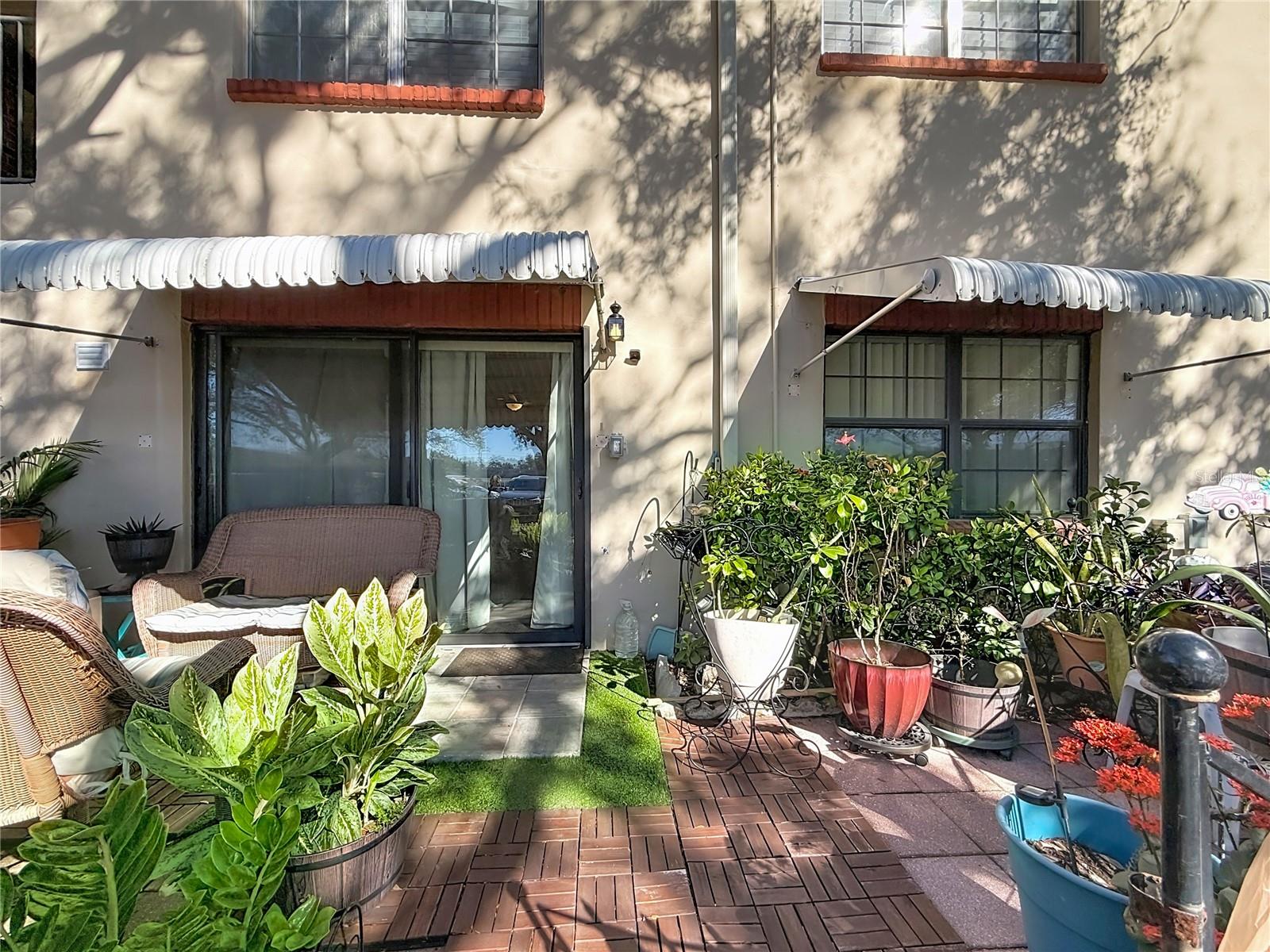 1020 85th Ave N no 119, back patio, sliders to kitchen and window to primary bedroom