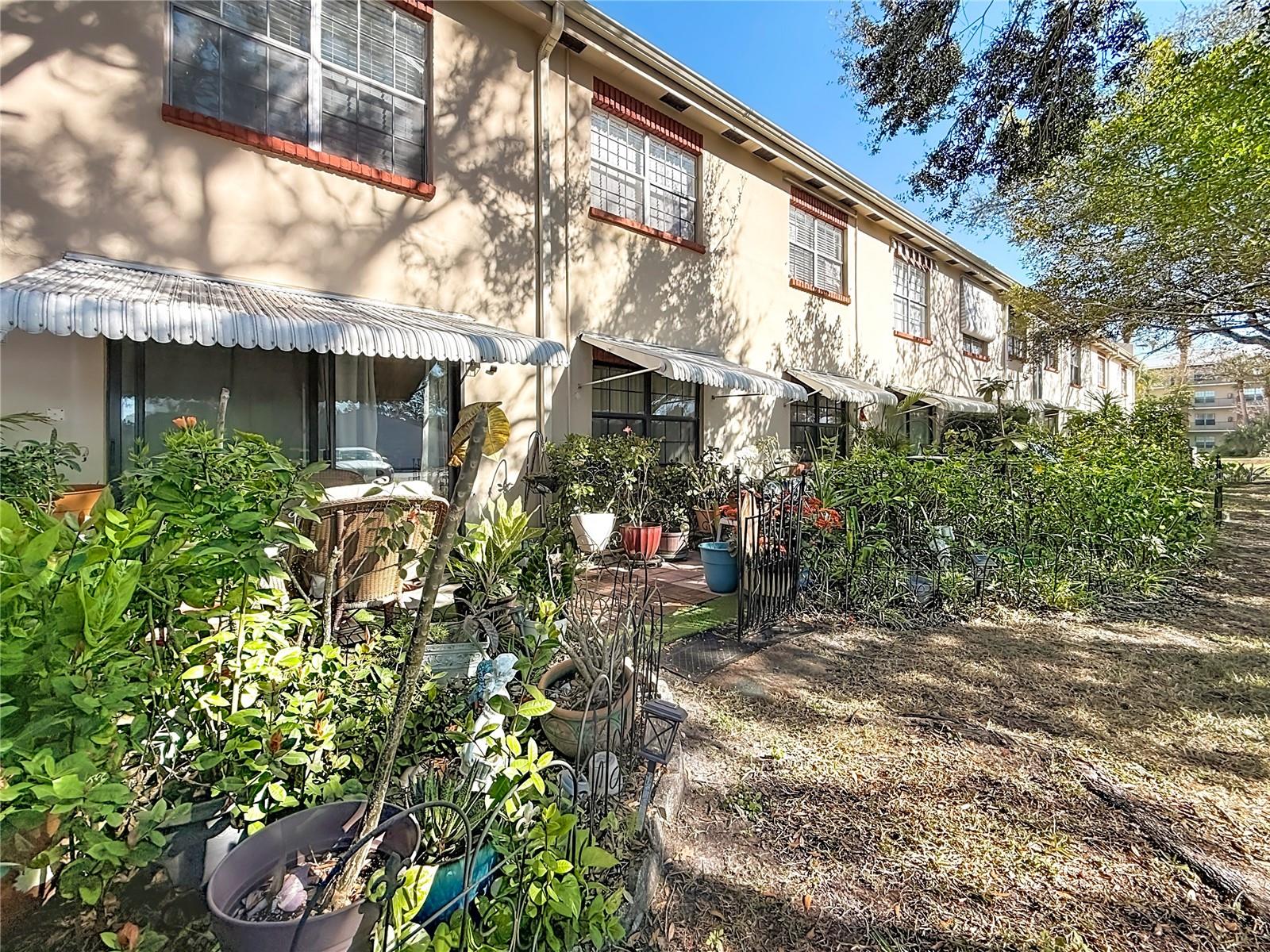 1020 85th Ave N no 119, view of back of building, patio and garden